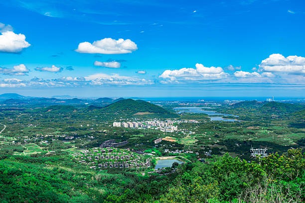 istock Panoramic high-angle view of a lush green landscape stretching to the distant ocean 2253224215
