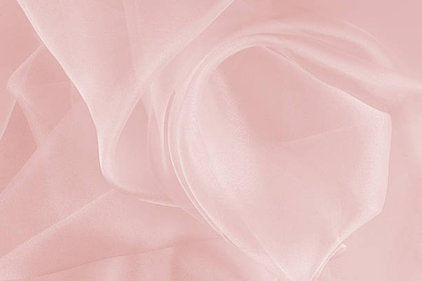 istock Soft, delicate white organza fabric on a peach background. Abstract holiday background. fabric texture. layout for design. 2253225686