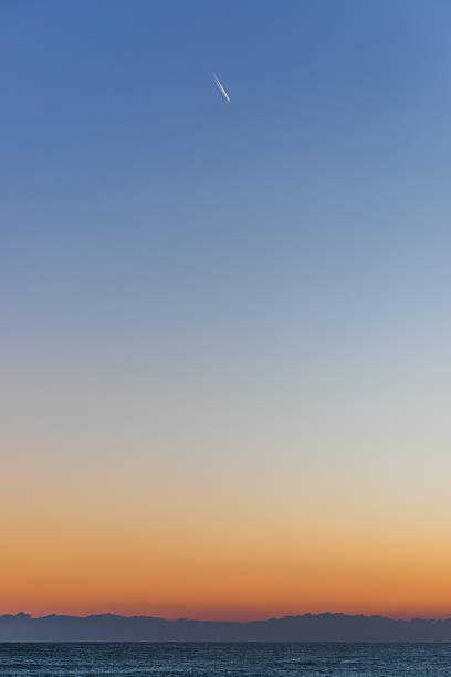 istock Single Airplane Contrail in Early Morning Sky 2253226952