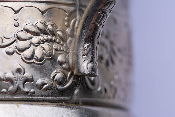 Detailed capture of a vintage silver object placed on a table, photographed in Mallorca, Spain, depicting beautiful craftsmanship amidst a natural and serene environment.