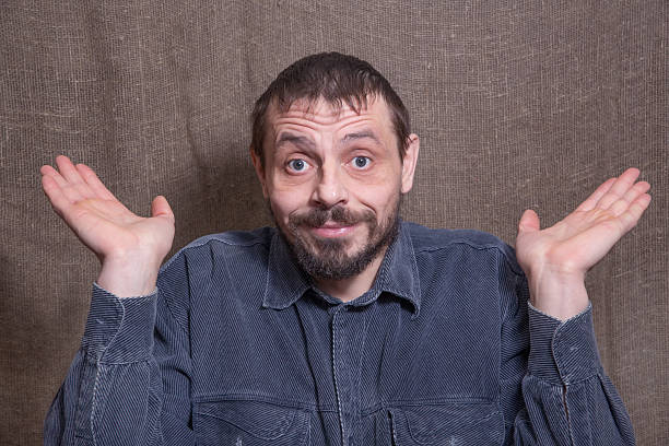 Funny man 40 years old. A European man smiles and spreads his arms to the side.