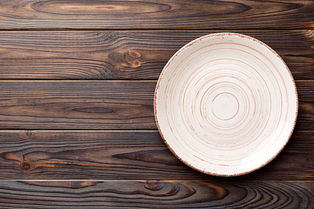 istock Top view of empty colorful plate on wooden background. Empty space for your design 2253230919