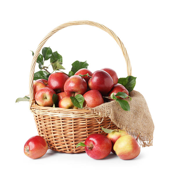 istock Fresh ripe apples in wicker basket isolated on white 2253231904