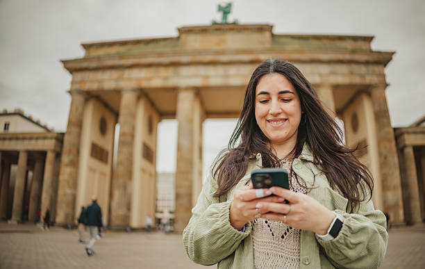 istock Visitors enjoy their time at Brandenburg Gate in Berlin while taking photos and interacting with their phones 2253234641