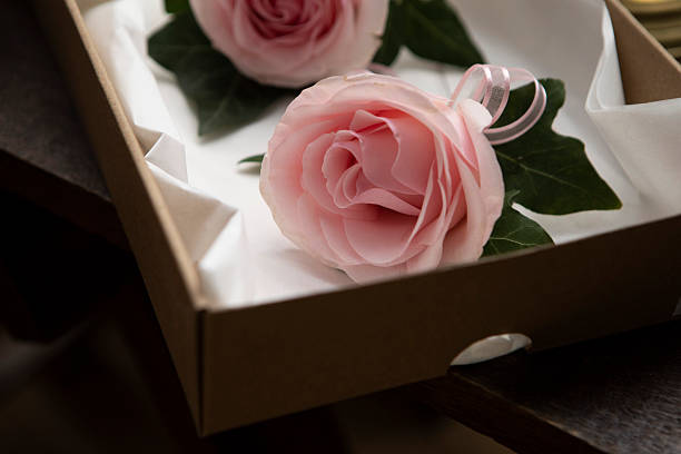 Pink-coloured buttonhole roses in a box - delivered before a wedding