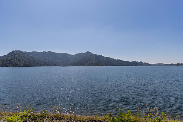 istock calm lake with mountain range, clear sky, khao yai, thailand — tranquil waterscape 2253237553
