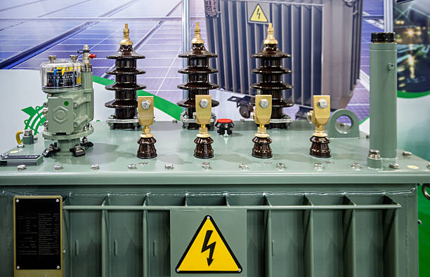 istock Close-up of a robust power transformer with ceramic insulators and a high voltage warning sign, symbolizing electrical energy distribution and industrial power infrastructure. 2253237834