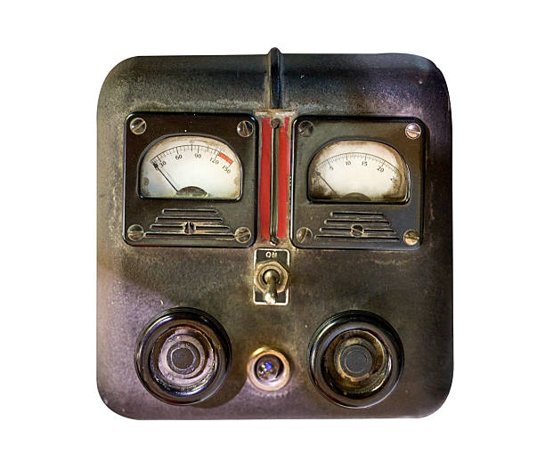 Front view of a vintage industrial control panel with analog gauges and switches, isolated on a white background. Retro mechanical device representing old technology, engineering, electricity, and industrial history.