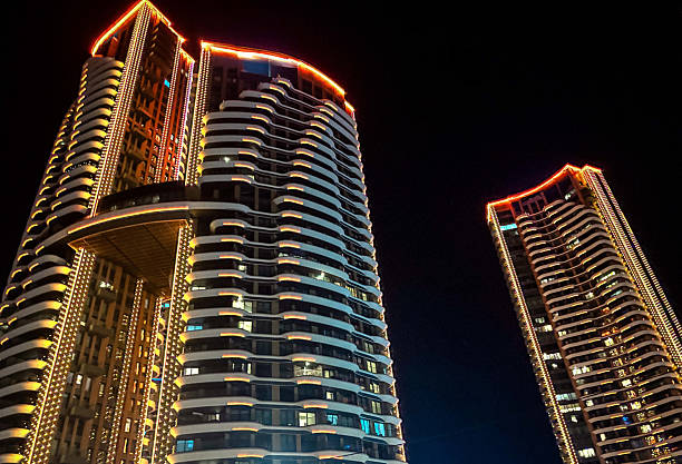 istock Two modern illuminated skyscrapers against black night sky 2253239310