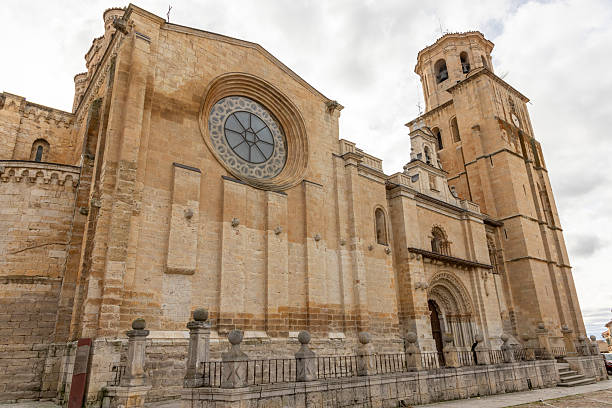 A large church with a large window and a bell tower in Toro, Spain. The building is old and has a lot of history.