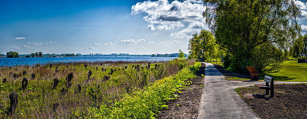 istock Paved walking path along Ameroever with lake view 2253240257