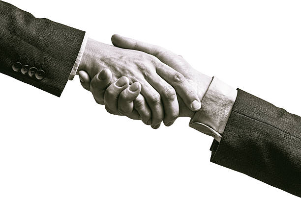 Black and white image of a firm handshake.