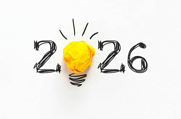 istock Creative 2026 concept featuring hand-drawn numbers and a yellow crumpled paper light bulb on a white background. A minimalist metaphor for new year innovation, bright ideas, and business goals 2253242714