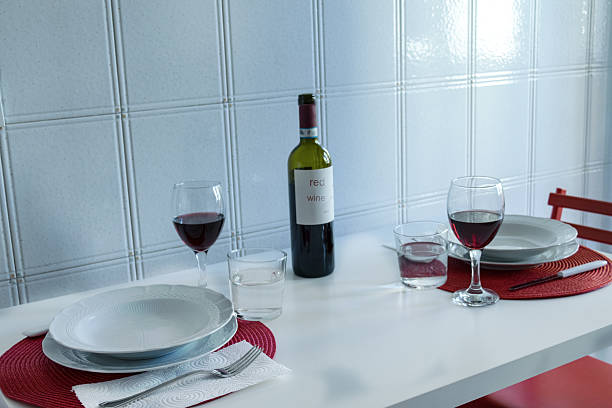 istock red wine bottle and glasses on elegant white dining table setting 2253243288