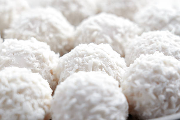White truffles with coconut flakes close up. Crispy sweet balls.