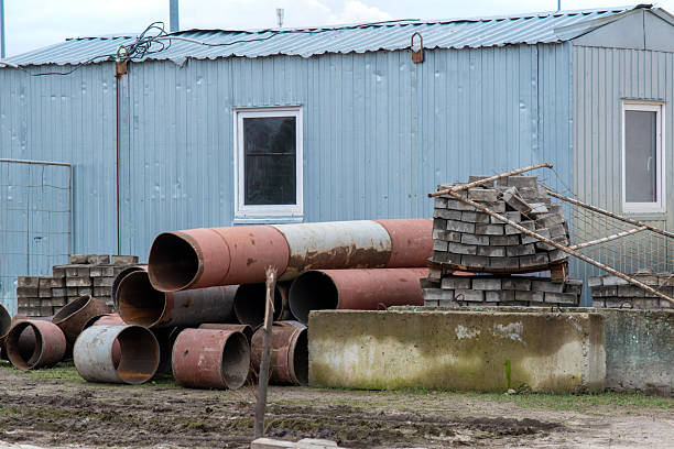 istock Construction materials storage with metal pipes and paving bricks 2253245629