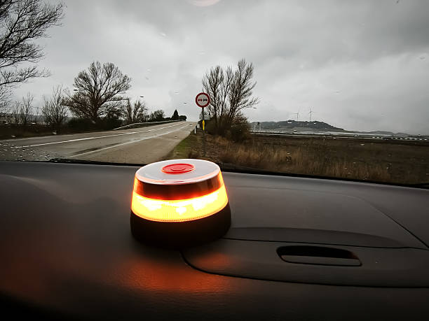 istock V16 beacon illuminated on vehicle dashboard ready to be rolled onto the roof. 2253249210