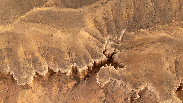 istock Rugged desert terrain with deep canyons and layered rock formations 2253251512