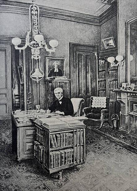 istock Antique illustration - Oliver Wendell Holmes sitting at a desk in his library 2253251623