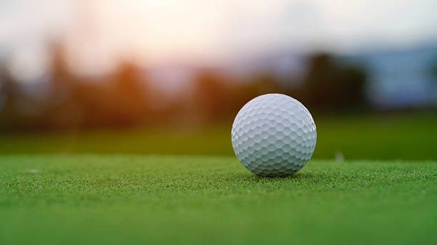 istock Golf ball on green grass in the evening golf course with sunshine background. 2253258364