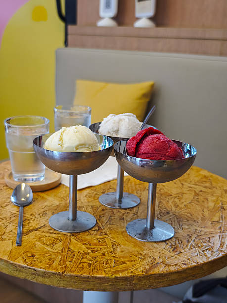 Ice cream metal bowls on tall legs with colorful ice cream scoops