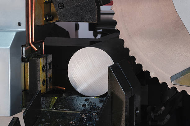 istock The automatic band saw machine cutting the metal bar with coolant method. The machine tool for industrial purpose. 2253259549