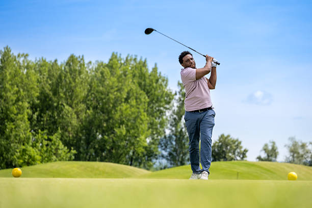 istock Young Hispanic Man Driving Golf Ball with Focus 2253260453