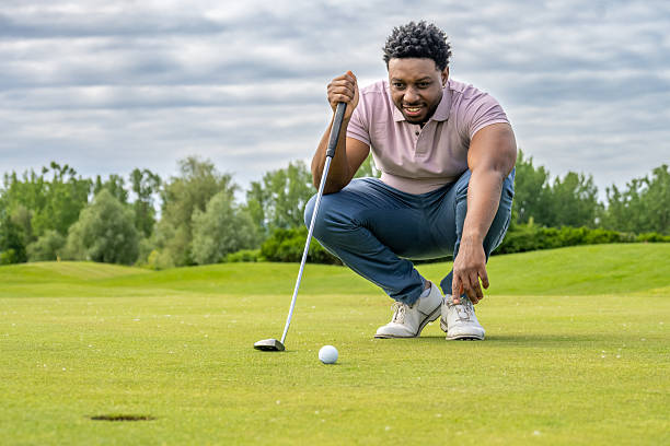 istock Young Hispanic Male Golfer Focusing on Precise Putt Alignment 2253260565