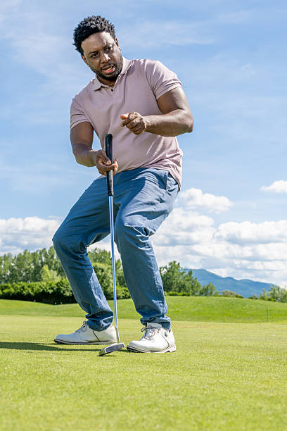 istock Focused Young Hispanic Golfer Preparing Putt on Clear Day 2253260864