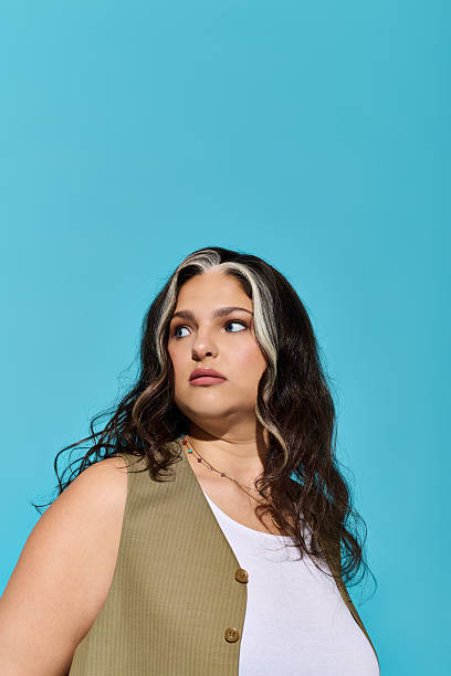 istock Beautiful woman with unique features embodies confidence against a bright blue backdrop 2253262084