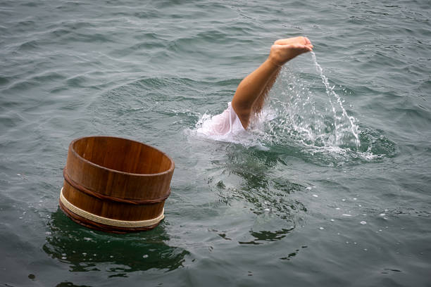 TOBA, MIE, JAPAN - 10 October 2025: Female Japanese ama is diving for pearl oysters and seafood like abalone during a demonstration on Mikimoto Pearl Island in Ise Bay, Toba. Ama divers never use diving apparatus