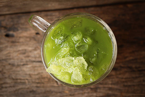 istock Iced green tea latte on wooden table 2253271034