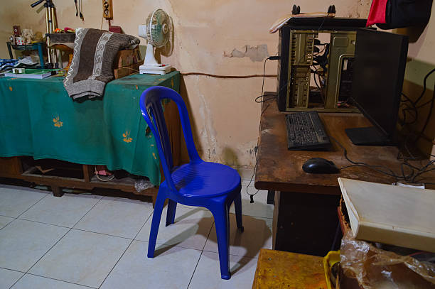 istock A Bright Blue Plastic Chair Sitting In A Cluttered Home Office Room 2253271327