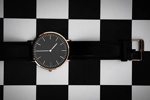 istock Minimal black wristwatch on checkered background flat lay 2253273679