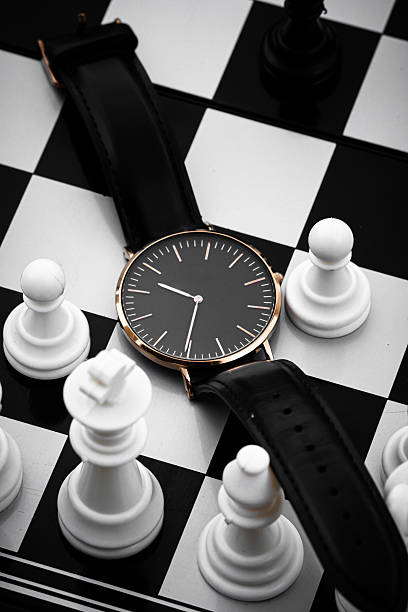 istock Wristwatch on Chessboard with Chess Pieces Representing Strategy and Time 2253273695