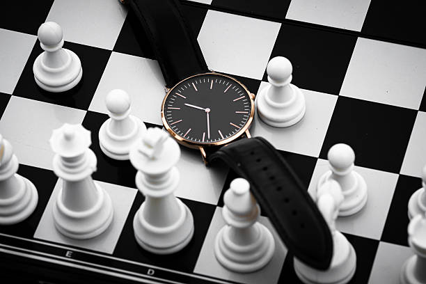 istock Wristwatch on Chessboard with Chess Pieces Representing Strategy and Time 2253273716