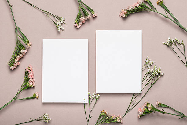 istock Two empty blank forms and pink flowers on a brownish background. Greeting card. 2253274563