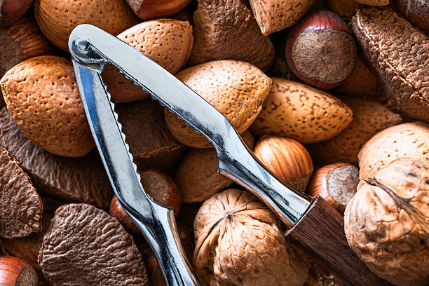 Close-up of bowl with nuts and nutcracker utensils