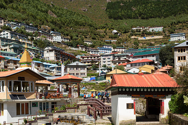 Namche Bazaar, Nepal - October 9, 2025: Trekkers enter the village of Namche Bazaar through a gate.