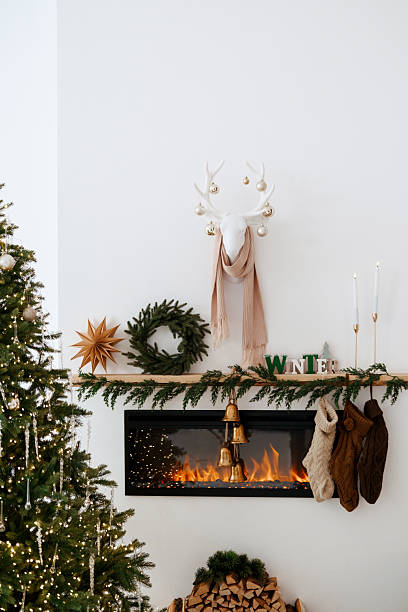 istock Cozy Christmas fireplace scene with decorated tree, stockings, and burning fire 2253278415