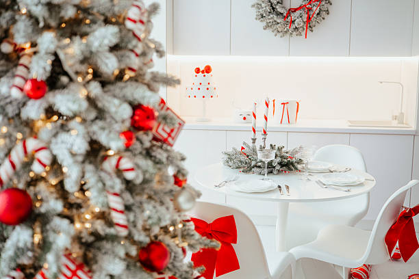 istock Elegant Christmas dining table setting with decorated tree and festive wreath in bright kitchen 2253278452