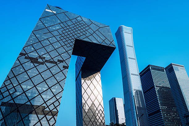 Beijing, China, October 11th, 2023:  A striking cluster of glass skyscrapers in Beijing features a bold arched structure. The ultra-modern design reflects a blue sky, conveying urban power, progress, and financial energy.