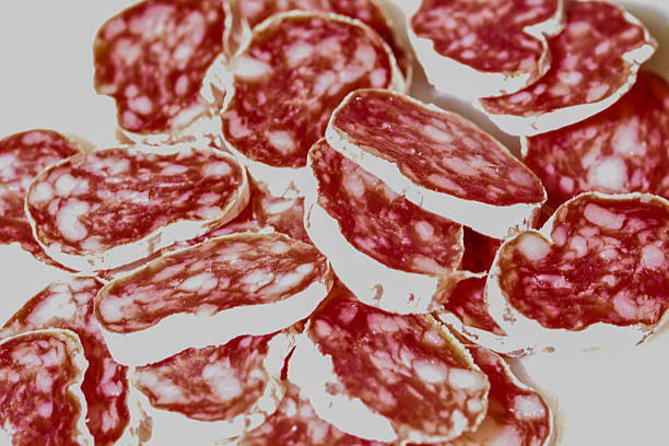 thinly sliced Spanish fuet sausage showing texture, marbling and traditional cured meat character, ideal for food concepts and culinary themes