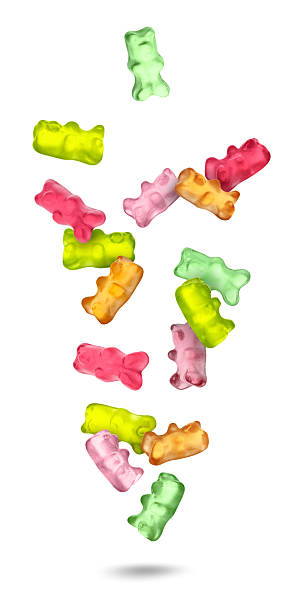 Gummy bears falling against white background. Sweet candy