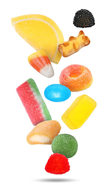 istock Different jelly candies falling against white background 2253280755