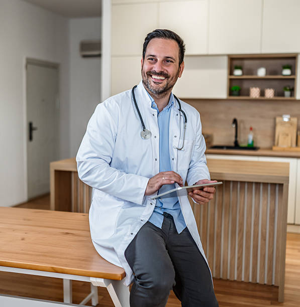 istock Doctor smiling working with digital tablet at home 2253282570