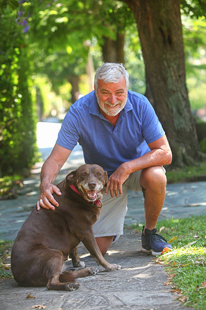 istock Senior man with dog outside. 2253282893