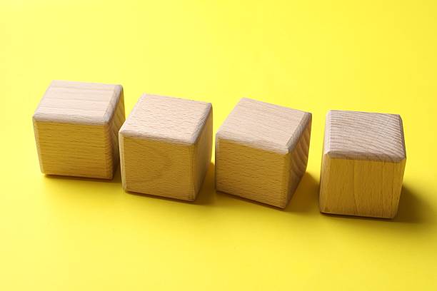 istock Blank wooden cubes on yellow background, closeup 2253283601