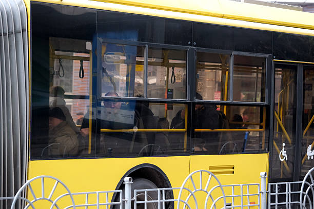A busy city bus filled with passengers travels along the road. Kyiv, Ukraine. December 5, 2025.