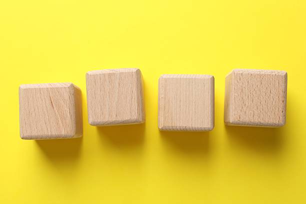 istock Blank wooden cubes on yellow background, flat lay 2253283895